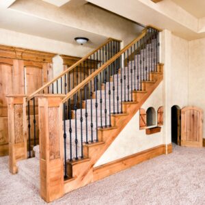 Wooden stairs going down into a basement. 