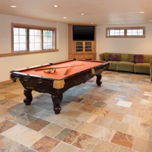 Basement with tile flooring and a pool table. 